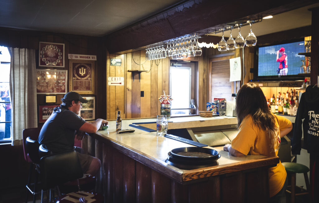 Patron and bartender at the bar at the Fireside Inn, Enochsburg, Indiana.