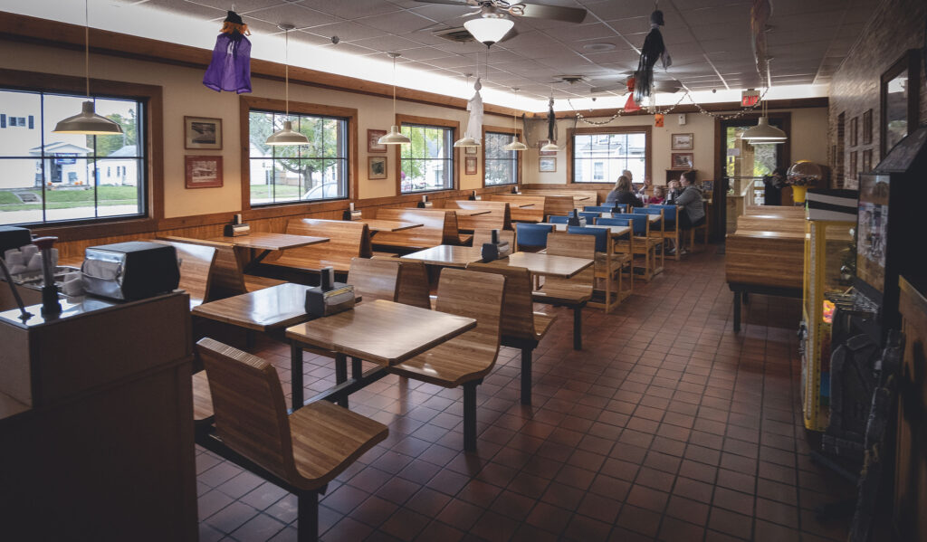 J's Dairy Inn interior showing red tile floor and wooden booths.